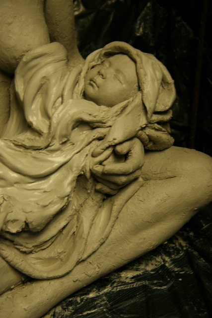 Indian baby in blanket sculpture.