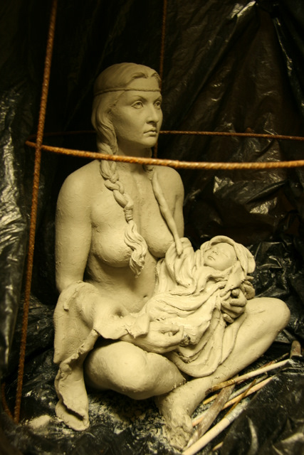 Indian woman (maiden) holding her baby.