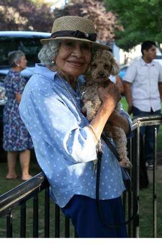 Luisa holding her companion poodle.